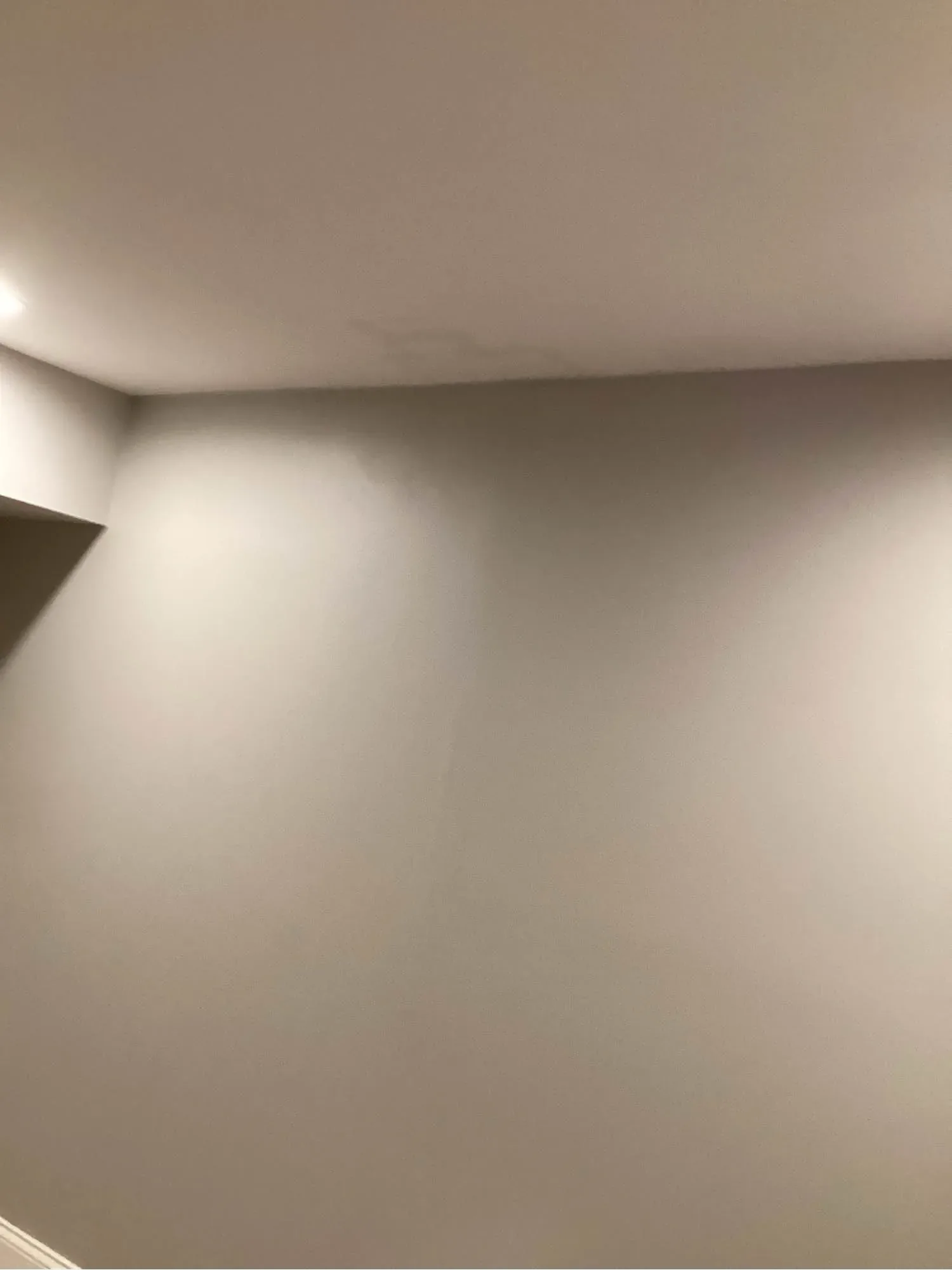 Ceiling stain spreading out from a corner where water has come through from above