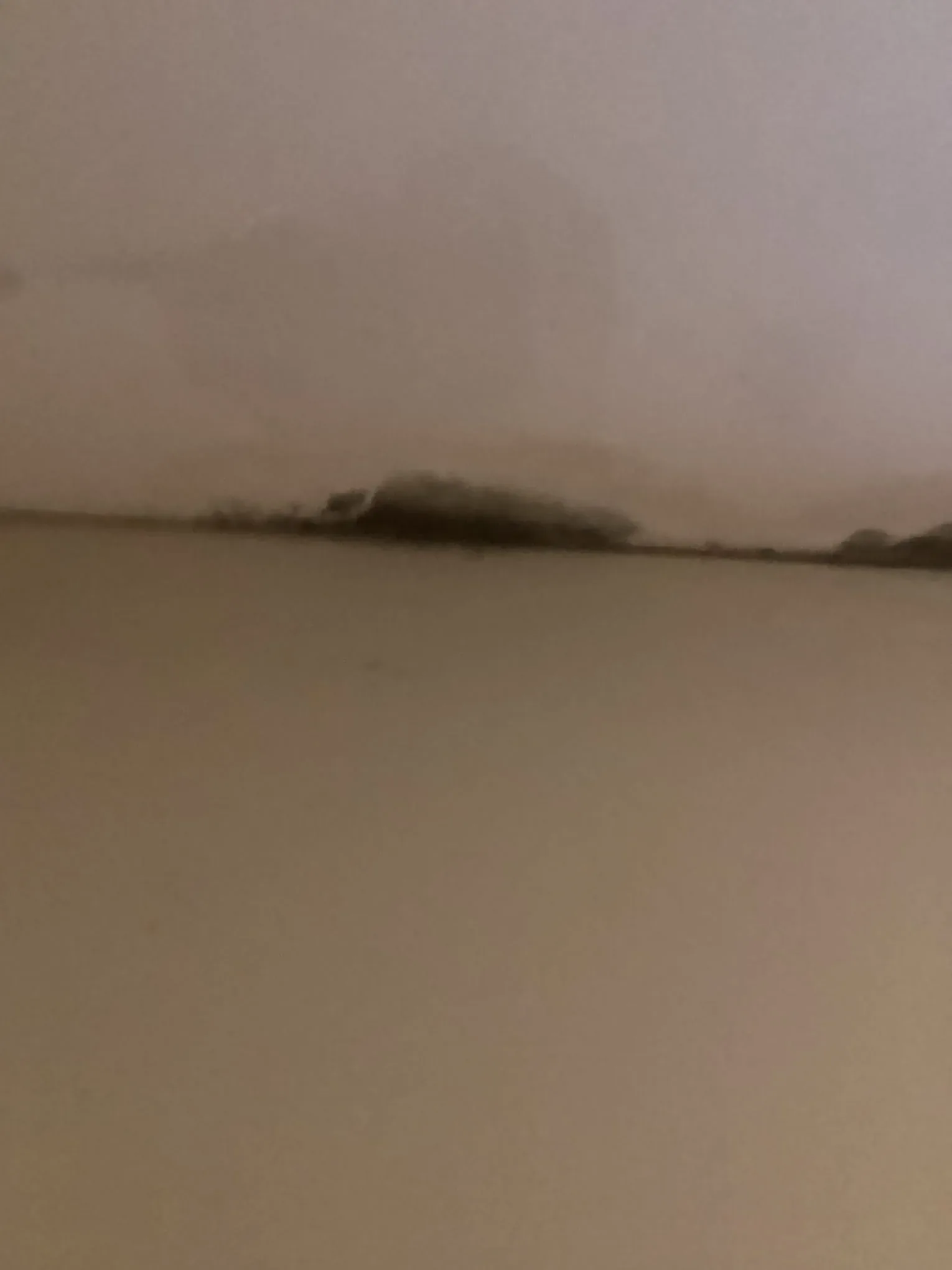 Interior wall and ceiling showing a horizontal water line where moisture has spread