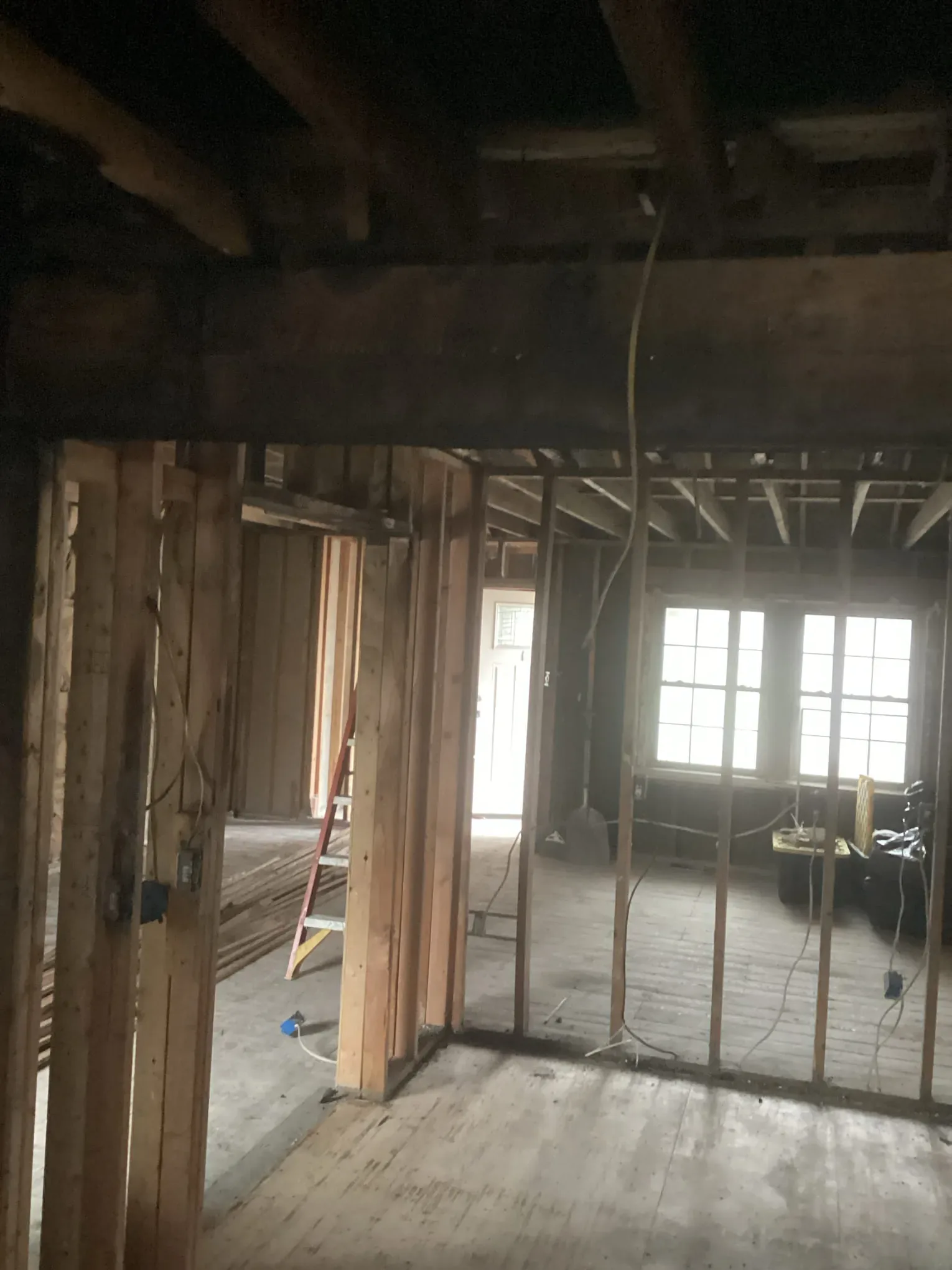 Interior stripped to the studs with smoke staining across the exposed framing