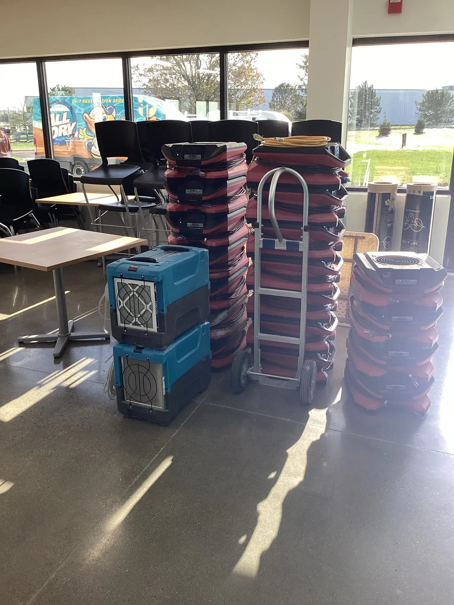 Commercial air movers and dehumidifiers staged on site before placement