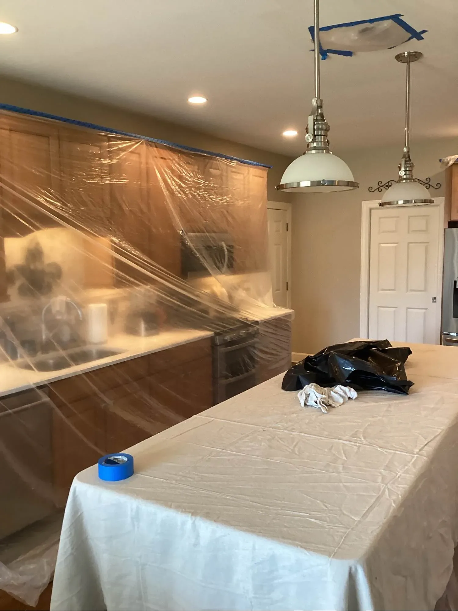 Room sealed behind plastic containment sheeting during restoration work