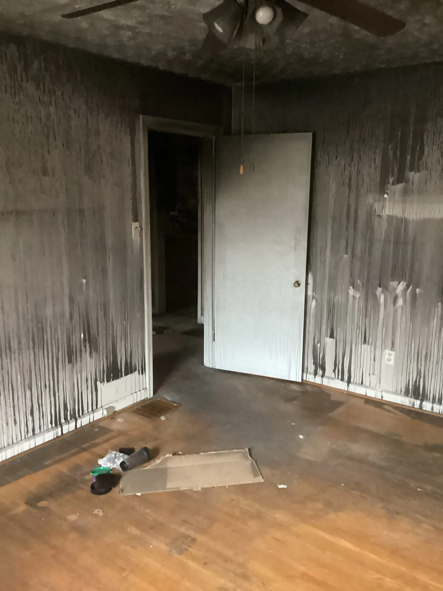 Room with soot streaked down the walls and around a doorway after a fire